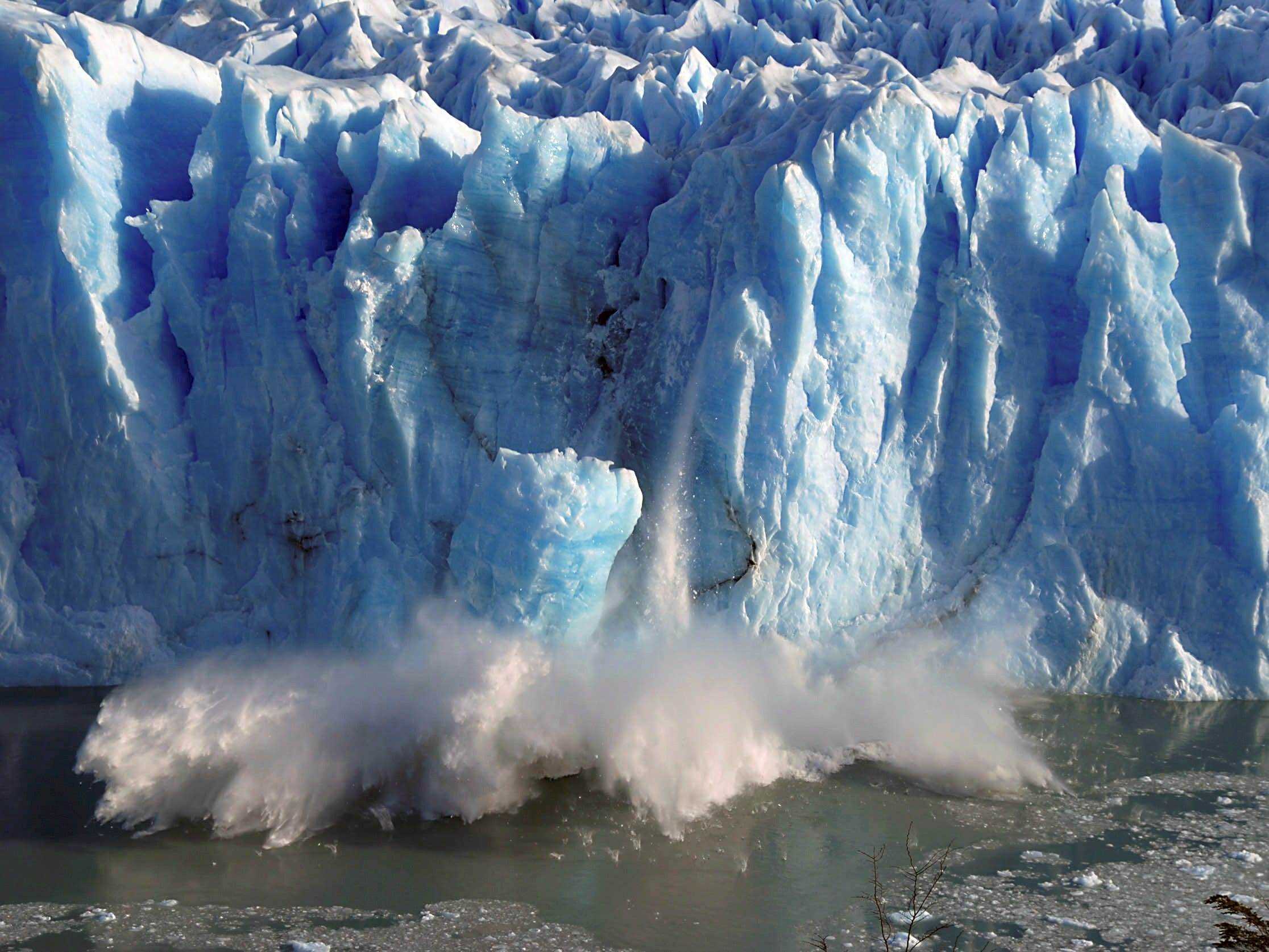 Gletscher kalbende Eissplitter fallen ins Meer