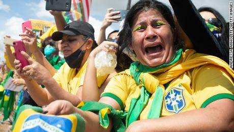Ein Anhänger des brasilianischen Präsidenten Jair Bolsonaro weint während einer Demonstration für seine Regierung inmitten der Coronavirus-Pandemie vor dem Planalto-Palast am 24. 