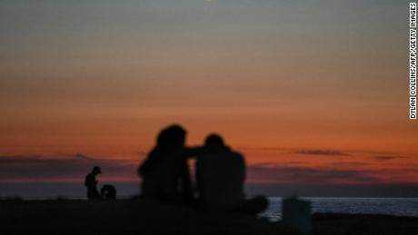 Ein Paar beobachtet im November den Sonnenuntergang in der Nähe von Beiruts Wahrzeichen Raouche Sea Rock. 
