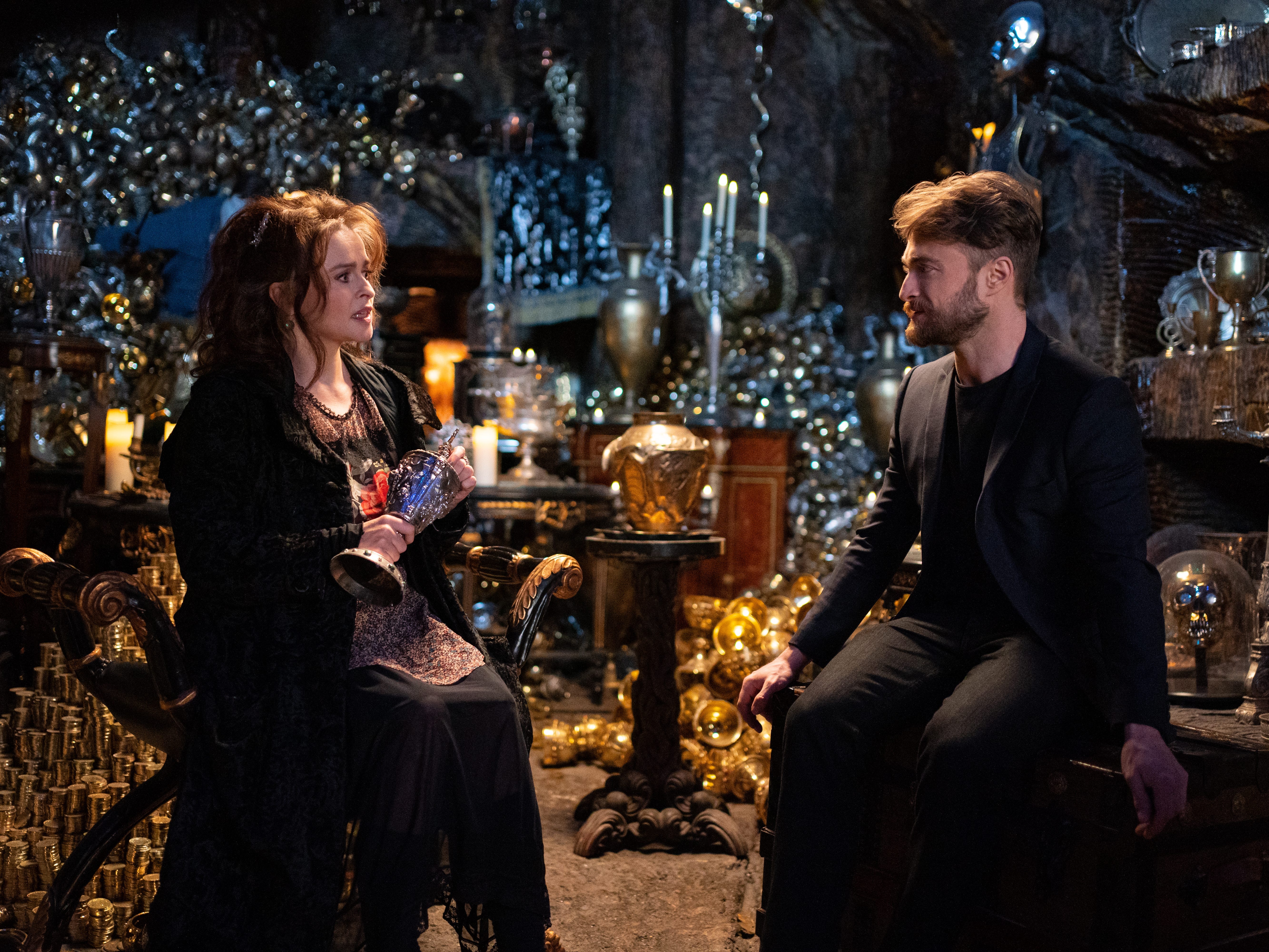 Helena Bonham Carter und Daniel Radcliffe sitzen 2021 zusammen und schauen sich in einer Nachbildung des Lestrange-Tresors in der Gringotts Bank im Harry Potter 20th Anniversary Reunion Special an