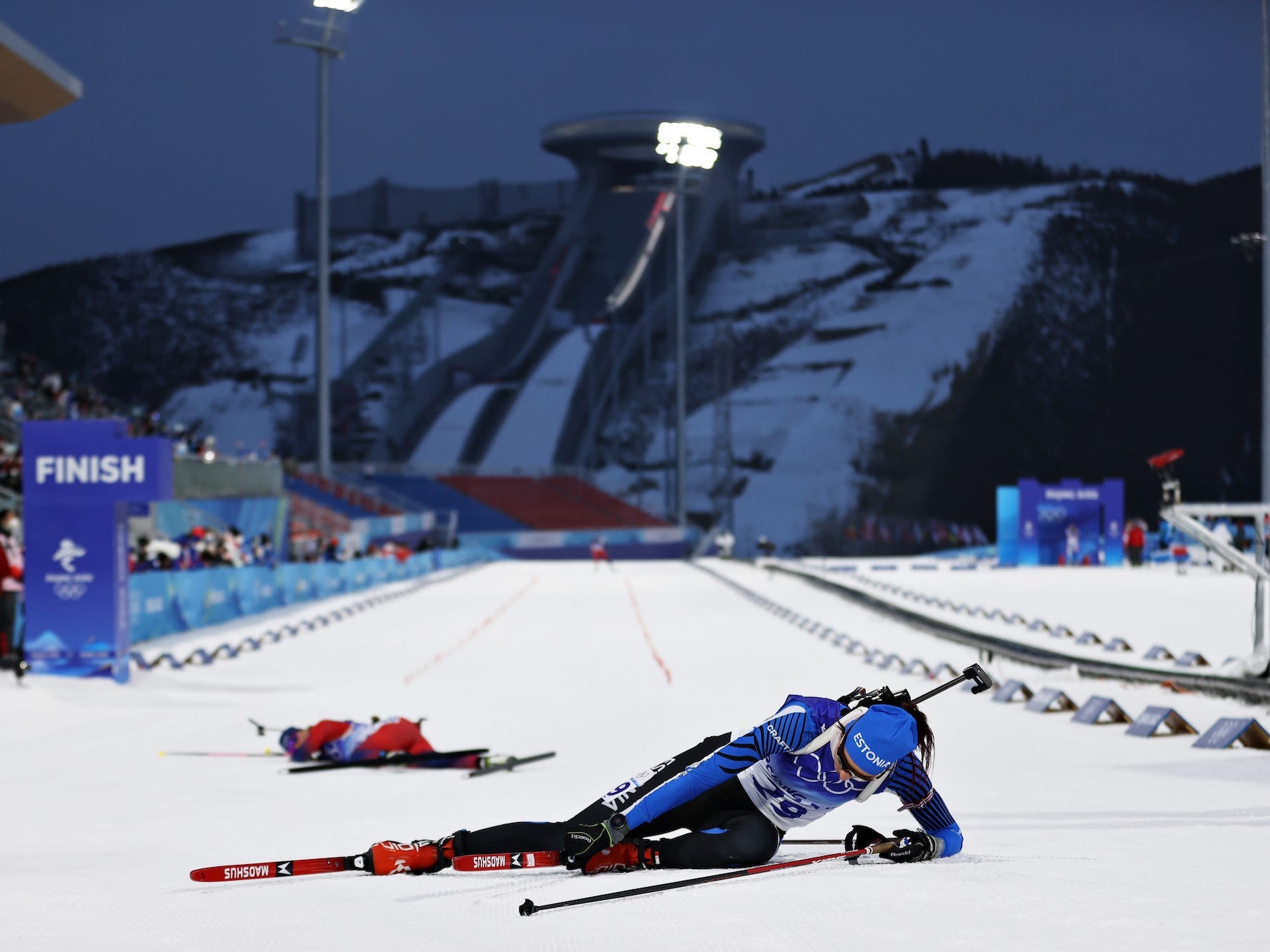 Tuuli Tomingas vom Team Estland bricht über die Ziellinie zusammen, als eine andere Skifahrerin im 7,5-km-Sprint hinter ihr liegt.
