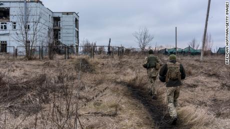 Ukrainische Soldaten gehen im Dezember auf ein zerstörtes Gebäude in Marinka in der Ukraine zu. 