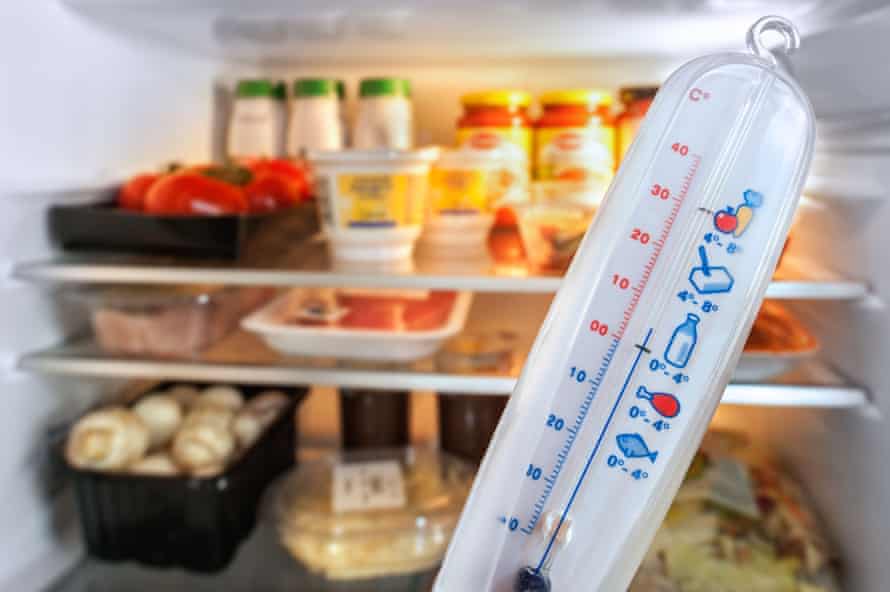 Ein Kühlschrankthermometer befindet sich vor einem Kühlschrank