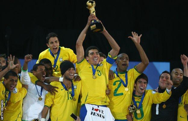 Lucio hebt die Trophäe des Konföderationen-Pokals 2009 hoch, mit einem T-Shirt mit der Aufschrift „I Love Jesus“, das über seine Shorts drapiert ist