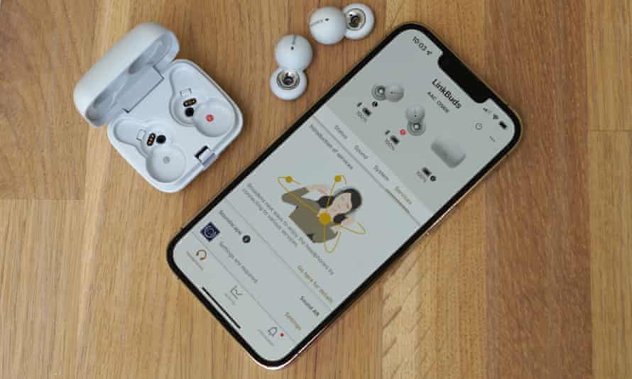 Die Headphones Connect App auf einem iPhone auf einem Tisch neben den LinkBuds und dem offenen Ladecase.