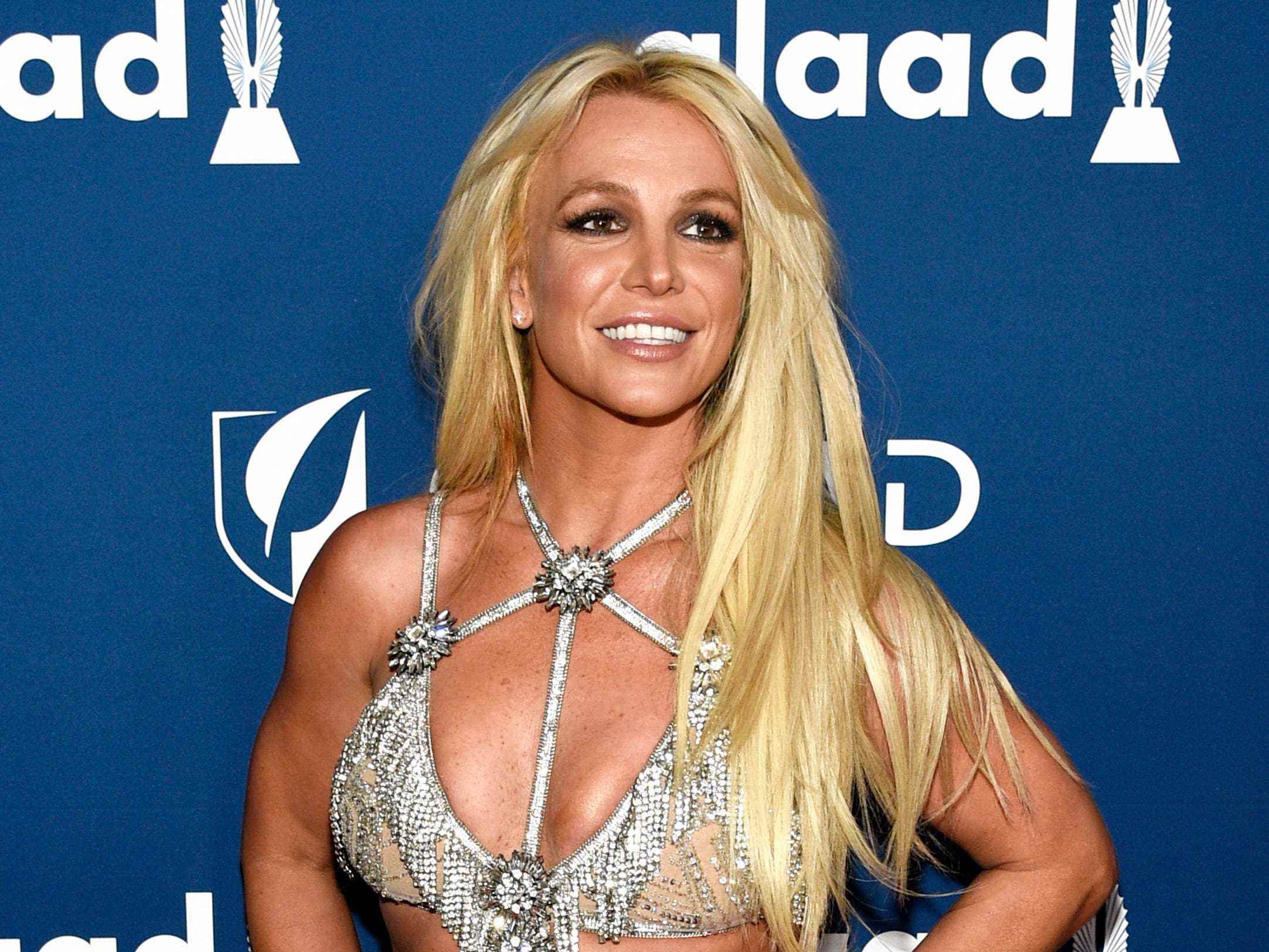 Britney in einem silbernen Strass-Trägerkleid.