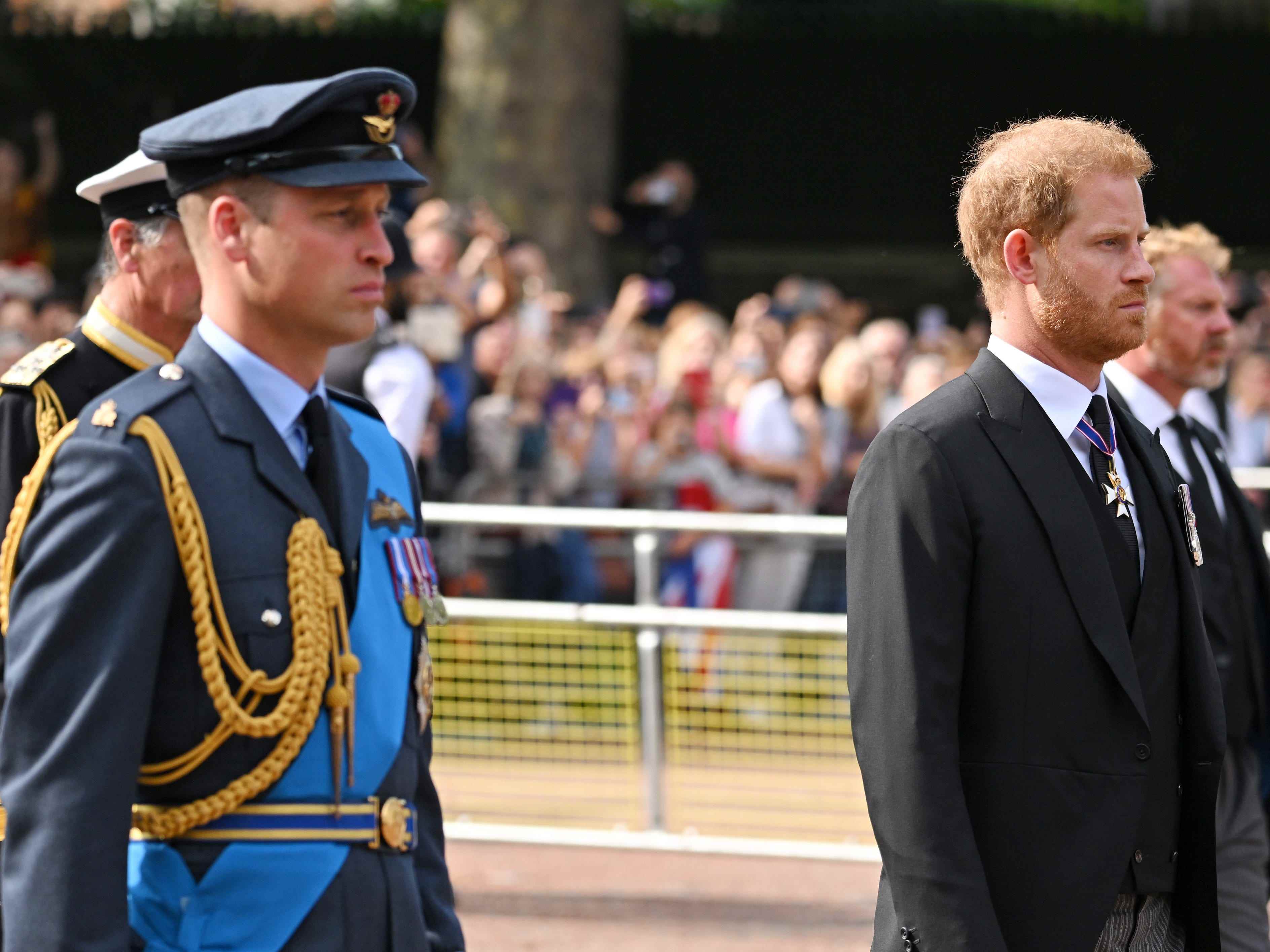 Prinz William, Prinz von Wales, und Prinz Harry, Herzog von Sussex, gehen während der Prozession für den Liegenden Staat von Königin Elizabeth II. Hinter dem Sarg.