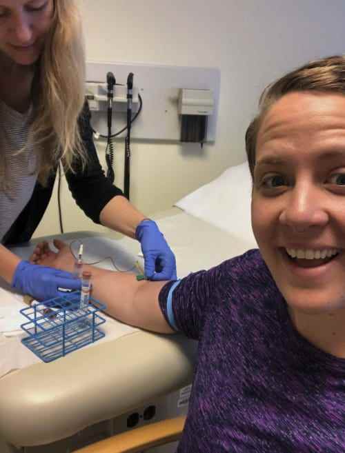 Frau lächelt, Blutabnahme im Malaria-Impfstoffversuch