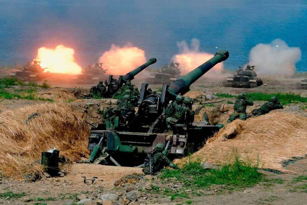 In den USA hergestellte CM-11-Panzer (im Hintergrund) werden während der 35. Militärübung „Han Kuang“ (Han Glory) im südtaiwanischen Landkreis Pingtung am 30. Mai 2019 vor zwei 8-Zoll-Artilleriegeschützen mit Eigenantrieb abgefeuert