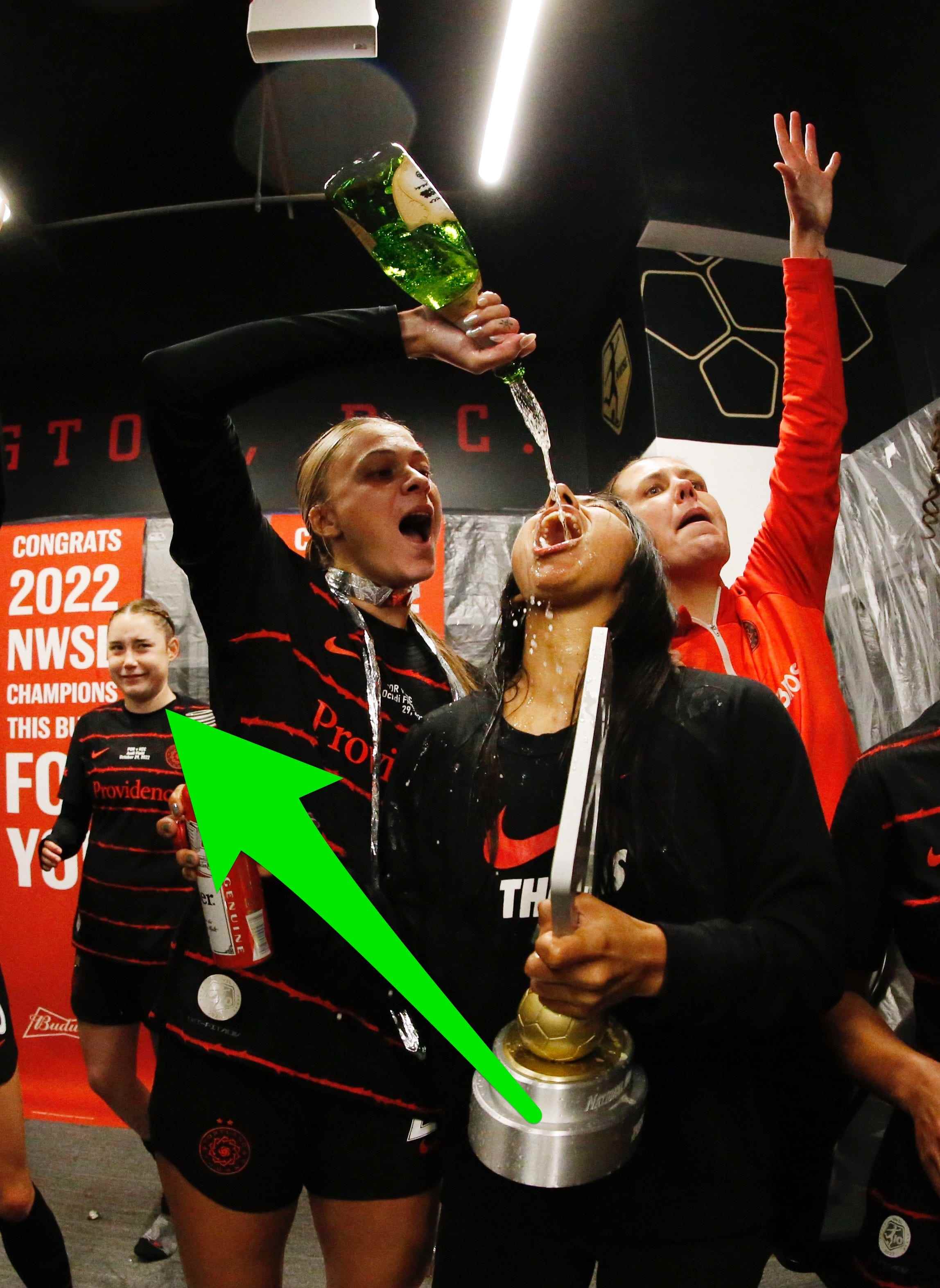 Olivia Moultrie sieht zu, wie ihre Teamkolleginnen ihren NWSL-Meisterschaftssieg mit Champagner und Bier feiern.