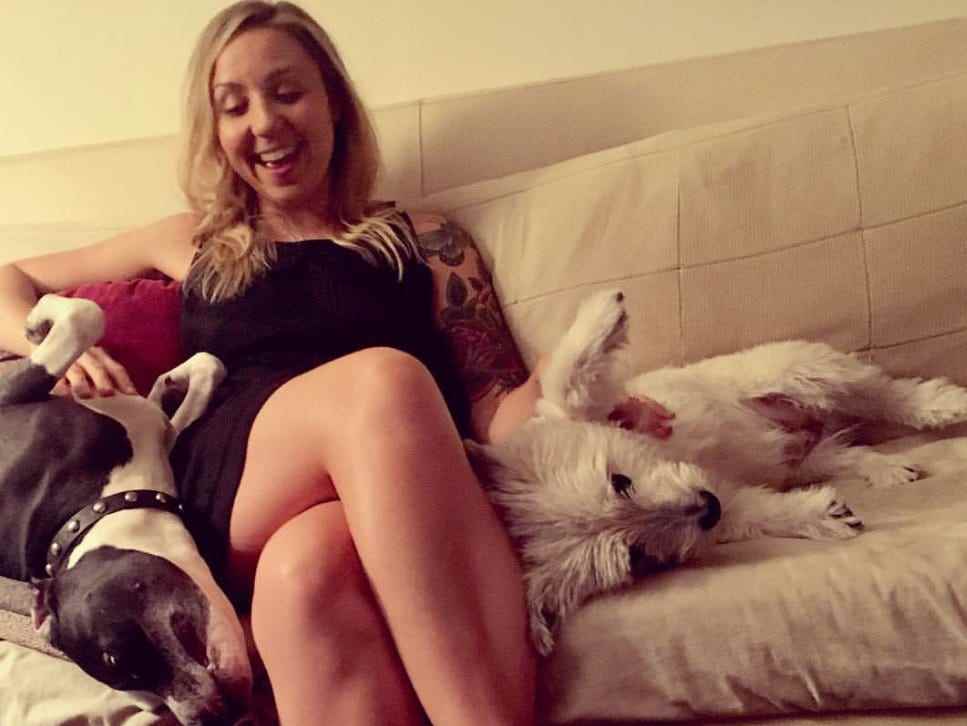 Melissa Petro, Mitte 20, sitzt mit zwei Hunden auf einer Couch