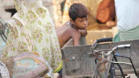 Ein kleiner Junge in den engen Gassen der Slums im Bhalswa Dairy Village.