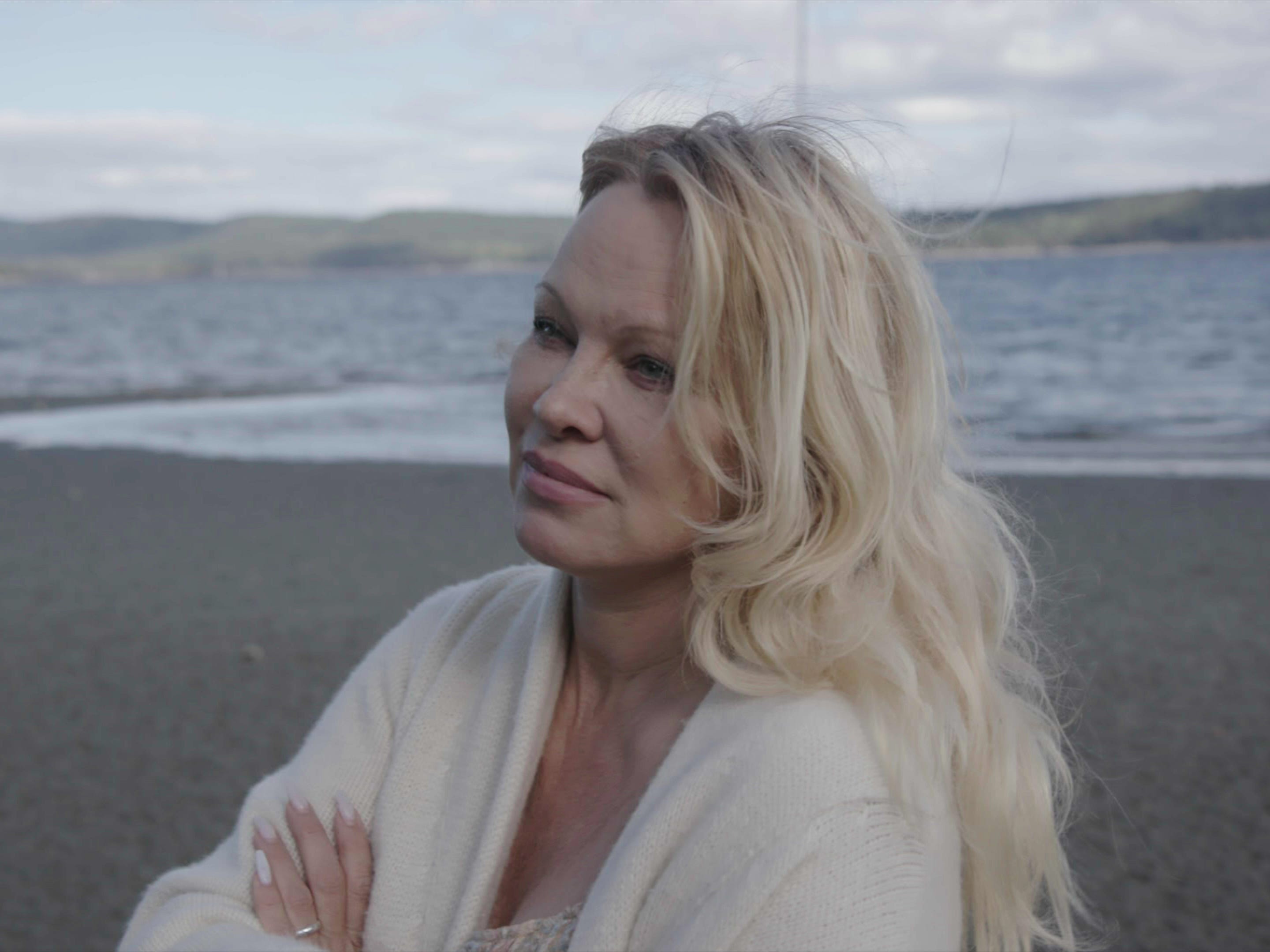 Pamela Anderson steht an einem Strand