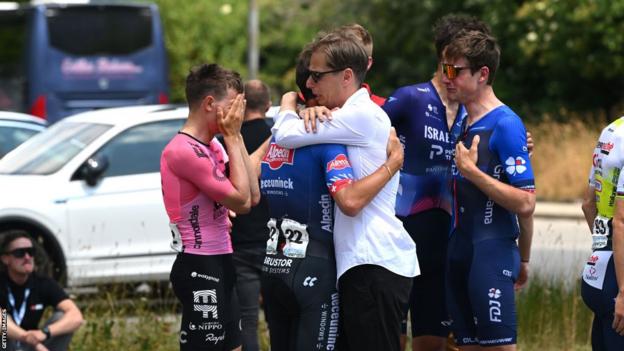 Die Fahrer der Tour de Suisse trösten sich gegenseitig, nachdem sie vom Tod von Gino Mader erfahren haben