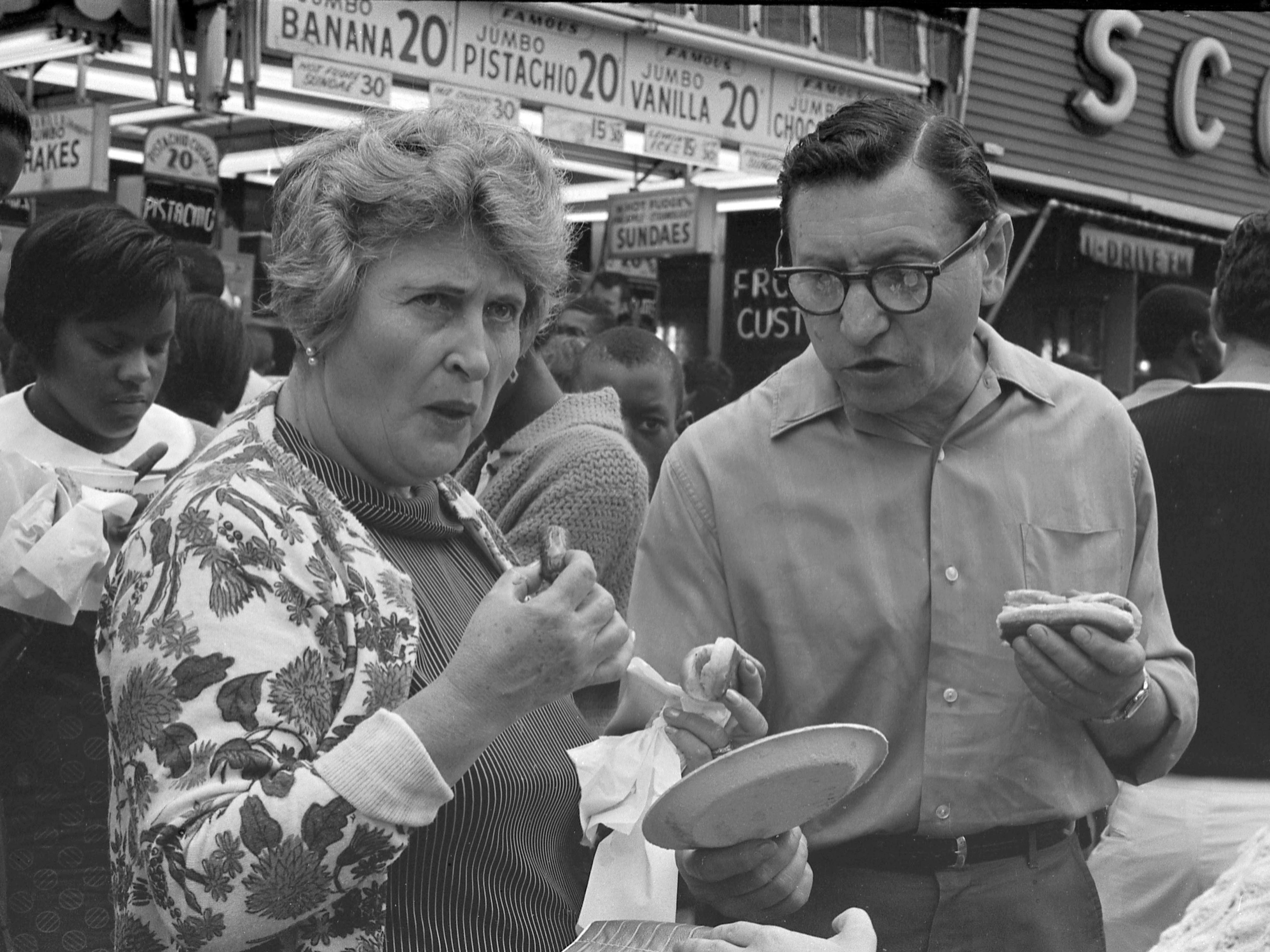 Ein Paar isst am 4. Juli 1968 Hot Dogs vor Nathan's Famous Fastfood-Restaurant auf Coney Island