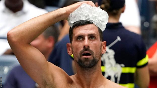 Novak Djokovic hält einen Eisbeutel auf seinem Kopf