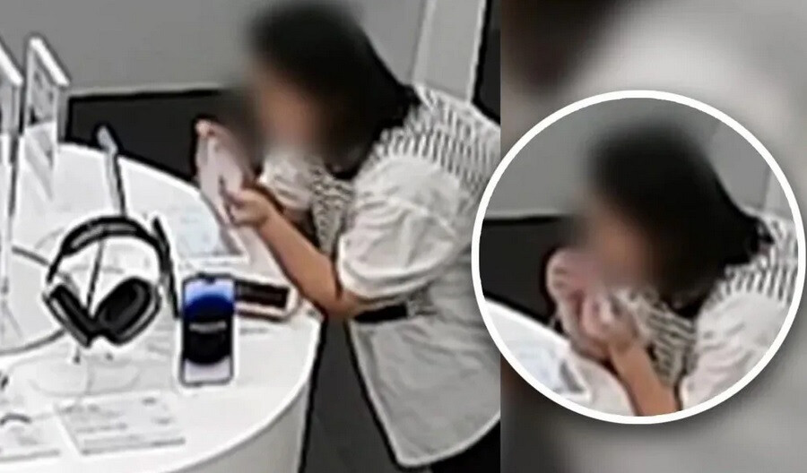 Die Sicherheitskamera des Apple Stores filmt eine Frau, die in das Diebstahlsicherungskabel beißt, um ein iPhone 14 Plus zu stehlen.  Bildnachweis: SCMP – Der Dieb im Apple Store stiehlt das iPhone 14 Plus mit einem einzigartigen Plan, bevor er erwischt wird