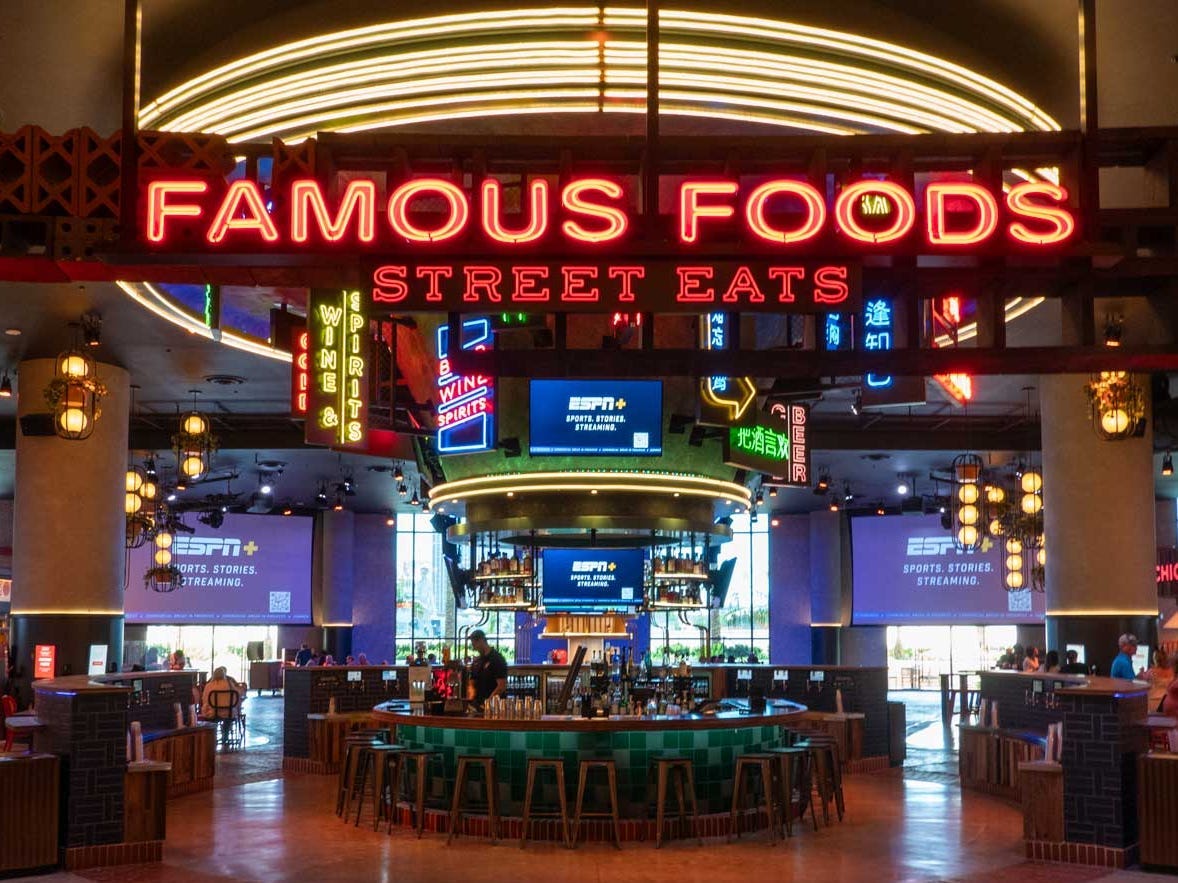 Eine Lebensmittelhalle mit einer Leuchtreklame mit der Aufschrift „Famous Foods Street Eats“