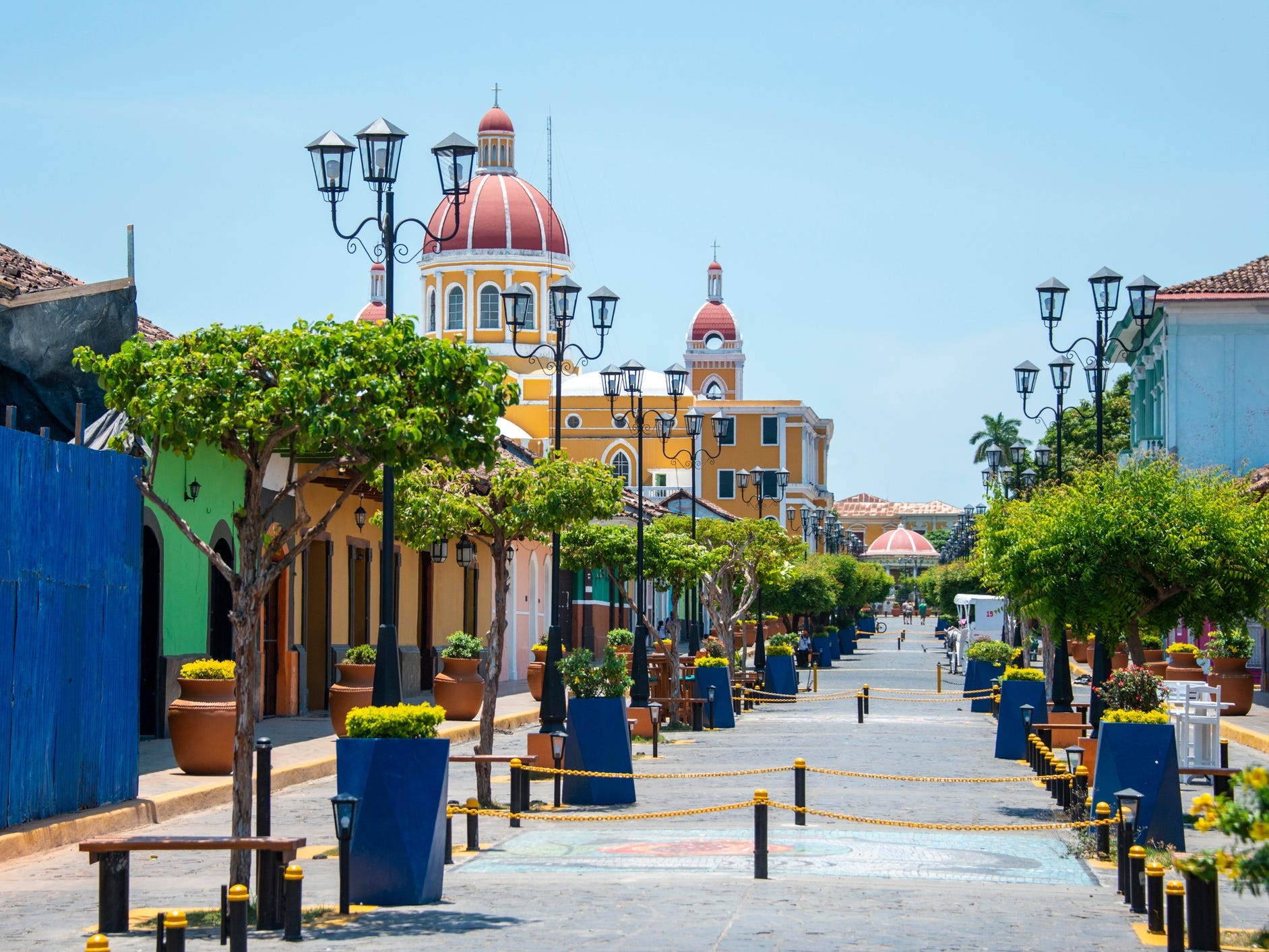 Eine farbenfrohe Straße in Granada, Nicaragua mit einer Kathedrale im Hintergrund
