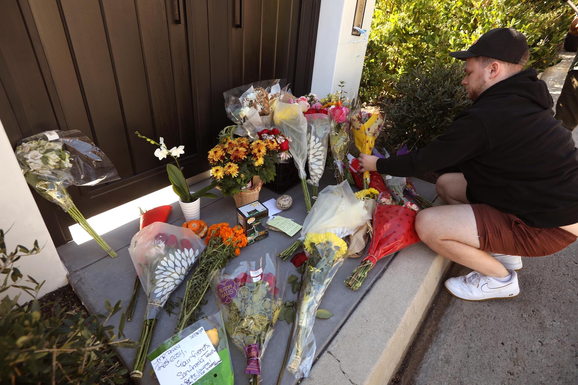 Samuel Miller, 26, hinterlässt am 30. Oktober 2023 Blumen an einem wachsenden Denkmal für den Schauspieler Matthew Perry vor seinem Haus in Pacific Palisades.