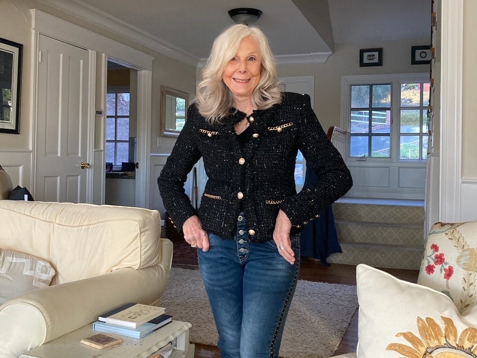 Donna Sasse in ihrem Wohnzimmer in Jeans und schwarzer Jacke.