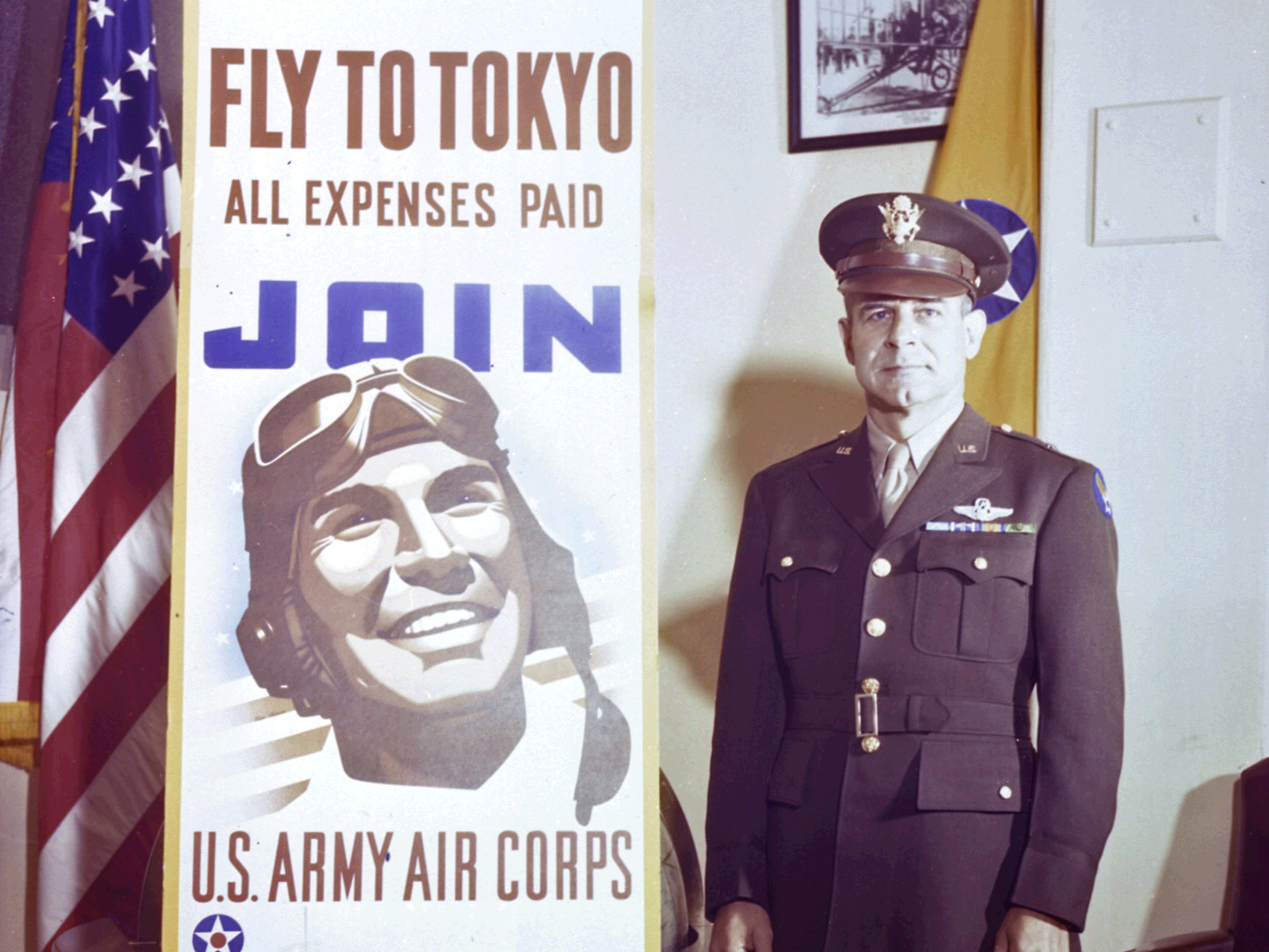 Porträt des amerikanischen Brigadegeneral James Doolittle (1896 - 1993), wie er neben einem Rekrutierungsplakat des Army Air Corps steht, 1943
