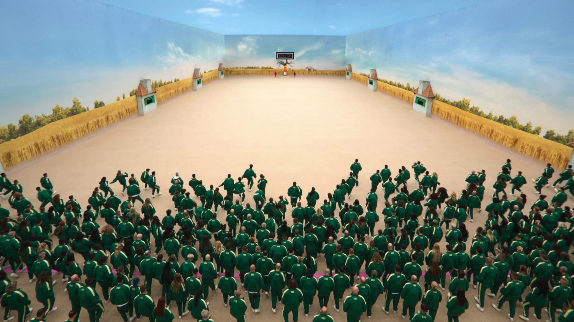 Eine Menschenmenge in Grün, die in „Squid Game: The Challenge“ durch einen Raum rennt
