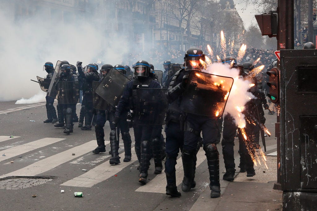 PARIS, FRANKREICH – 23. MÄRZ: Bei gewaltsamen Zusammenstößen wegen der Reform des Rentensystems durch die Regierung am 23. März 2023 in Paris, Frankreich, wird die Bereitschaftspolizei von Feuerwerkskörpern getroffen.