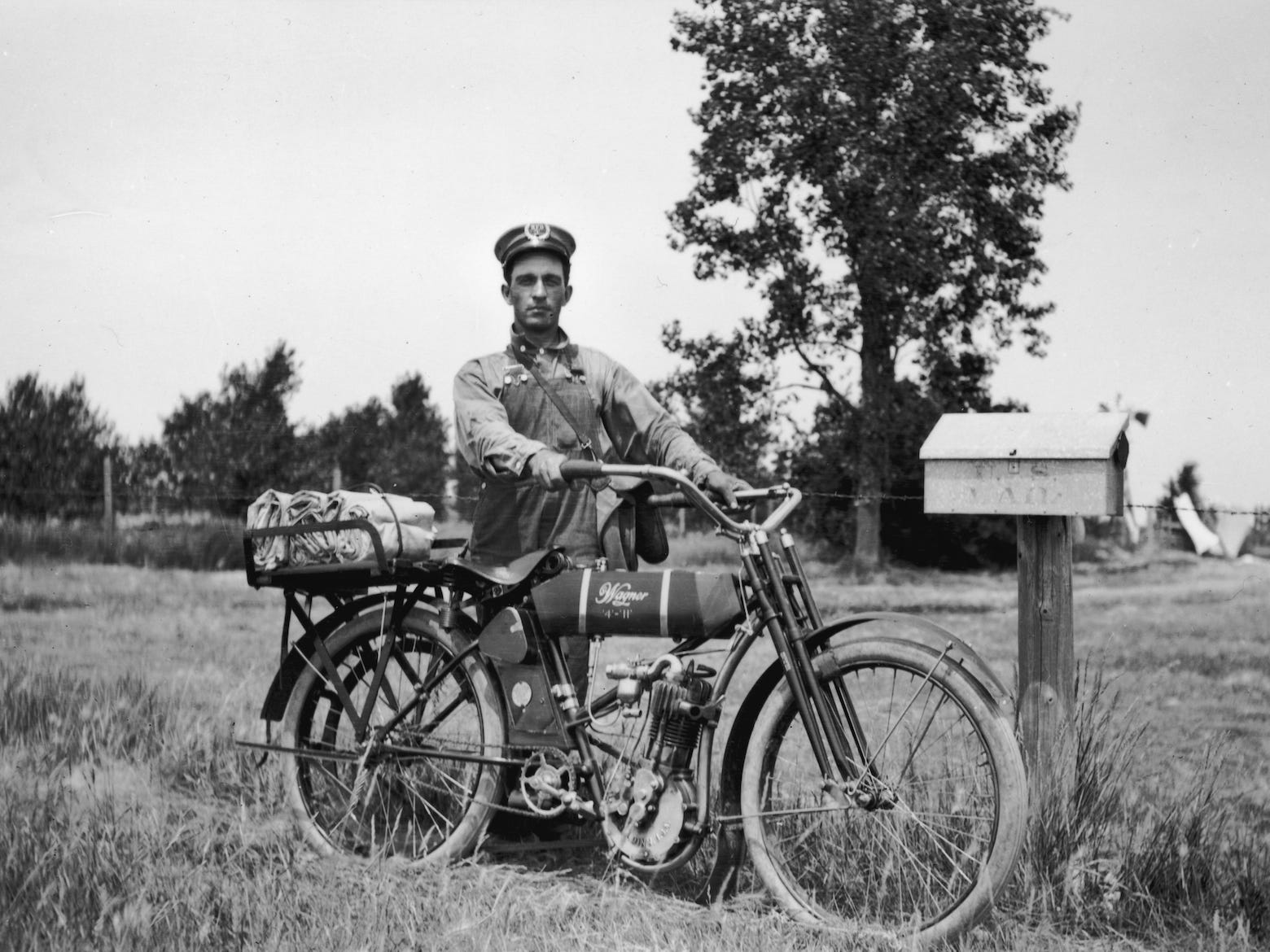 Ein Postangestellter fährt Motorrad