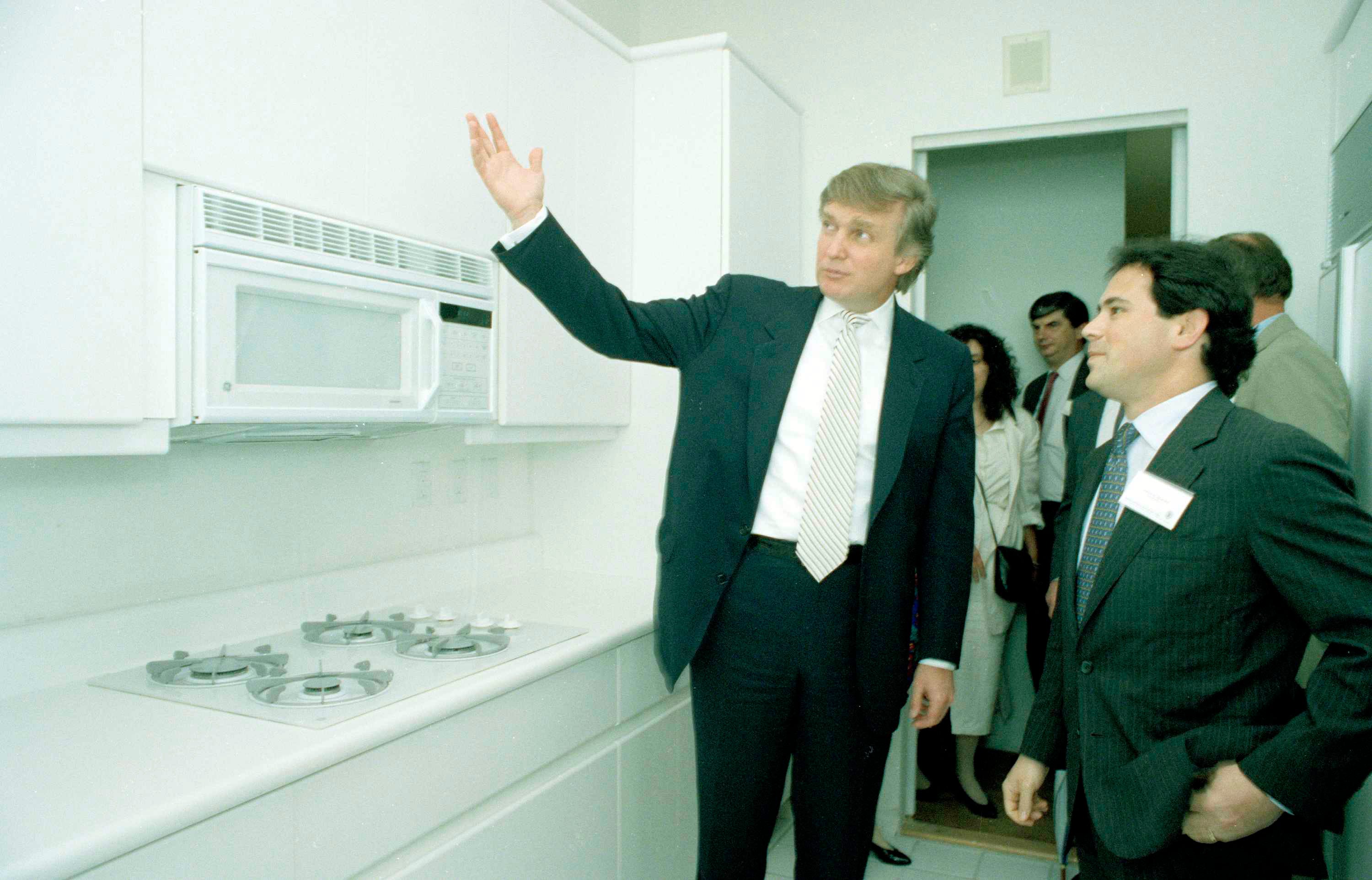 Ein Foto aus den 1990er Jahren, auf dem Donald Trump eine komplett weiße Küche in den neuen Trump Palace-Apartments zeigt.