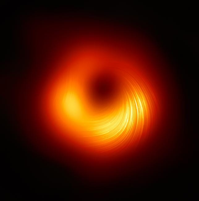 Das Bild eines Schwarzen Lochs zeigt eine leuchtend rote Scheibe, deren untere Hälfte leuchtend gelb und voller Streifen ist, die sich nach außen wölben