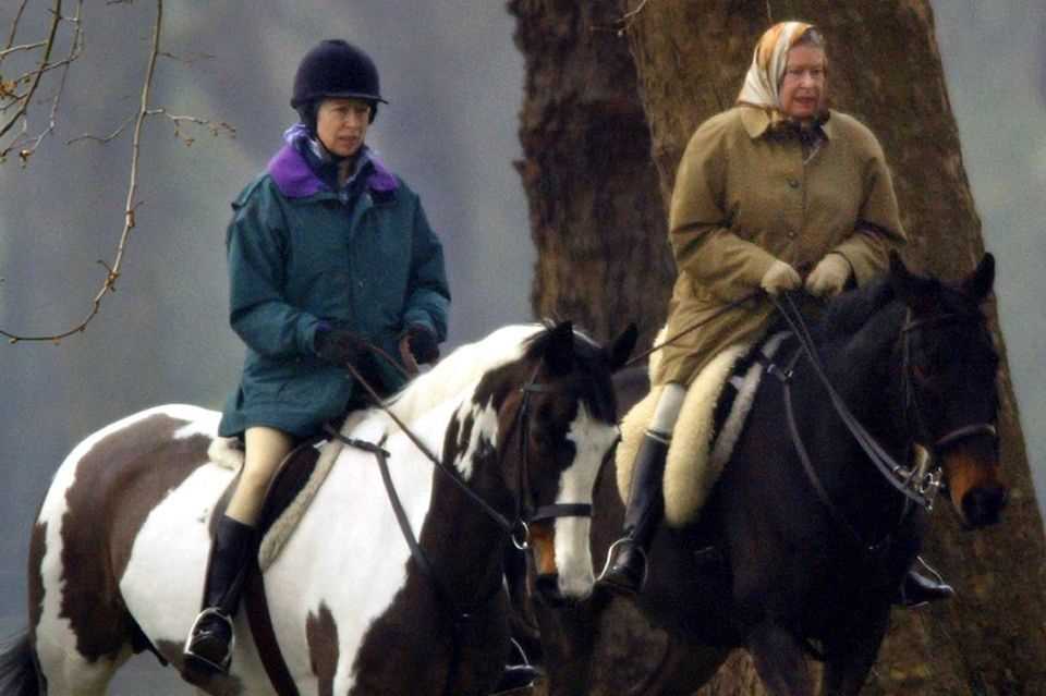 Queen Elizabeth on horseback with daughter Anne on the grounds of Windsor Castle.