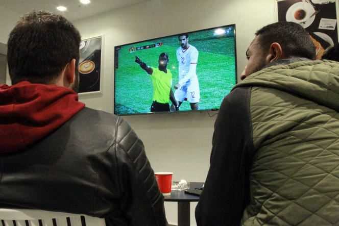Fans watch the match between Libya and Tunisia at a cafe in Benghazi on March 25, 2021.