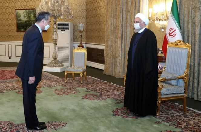 Chinese Foreign Minister Wang Yi greeted by Iranian President Hassan Rouhani in Tehran on March 27.