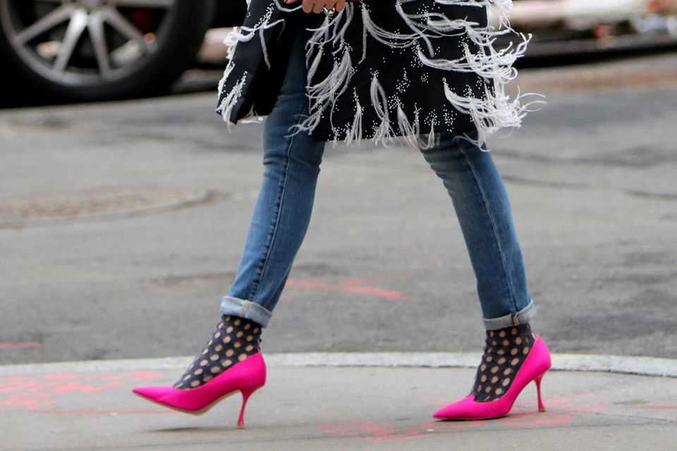 Olivia Palermo wears black fishnet socks with pink heels.