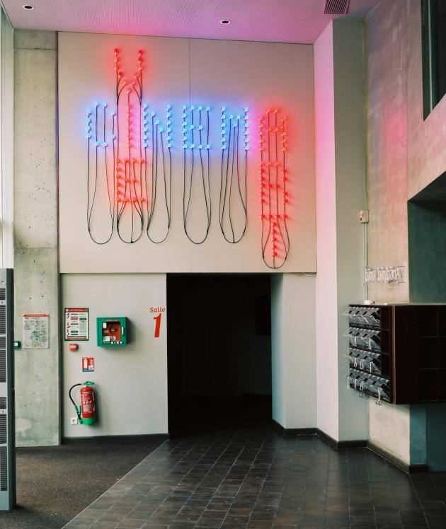 At the entrance to the MK2 Nation cinema, owned by the Karmitz brothers, a light installation by Christian Boltanski, “Cinema, art and life”.