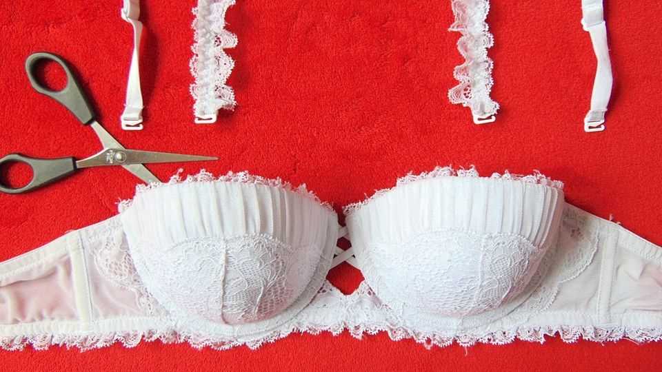 White bra on a red background with cut straps