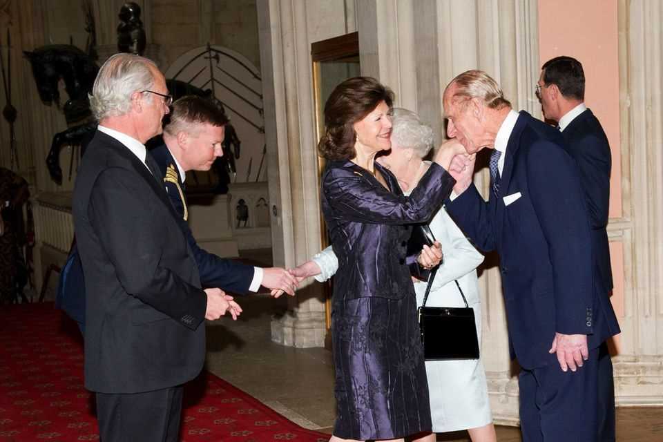 Kiss the hand Beautiful woman!  Prince Philip greets Queen Silvia for dinner at Windsor Castle in the presence of King Carl Gustaf and Queen Elizabeth.  They met in May 2012 on the occasion of the Queen's Diamond Jubilee. 
