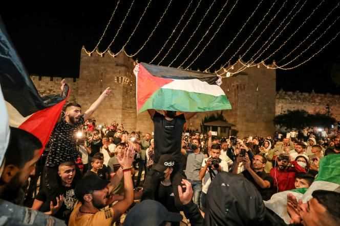 Palestinians wave their flags outside Damascus Gate on Sunday April 25.