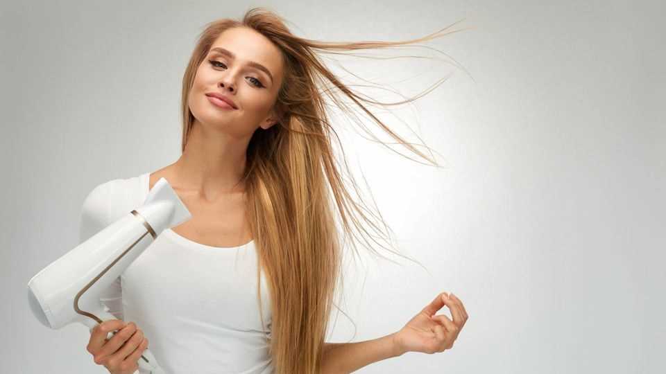 Woman in white blows her hair