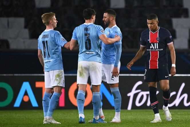 Manchester City players savor their victory at the Parc des Princes against PSG in the semi-final first leg of the Champions League on April 28.