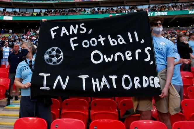 Manchester City supporters proclaim 'Fans, football, owners, in that order' during their side's League Cup final against Tottenham at Wembley Stadium in London on April 25.