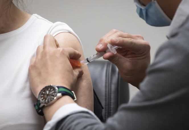 A Canadian pharmacist administers AstraZeneca's Covid-19 vaccine to a Vancouverite on April 1.