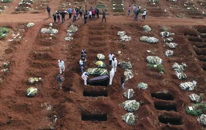 Employees at the Vila Formosa cemetery in Sao Paulo bury a person who died from complications from Covid-19 on April 7.