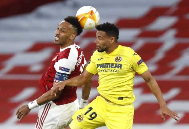 Pierre-Emerick Aubameyang (left) and Francis Coquelin head the ball during the Europa League semi-final second leg between Arsenal and Villareal, in London, on May 6, 2021.