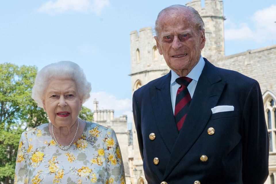 Queen Elizabeth and Prince Philip pose in front of Windsor Castle.  The photo was published by the palace on the occasion of Philip's 99th birthday.