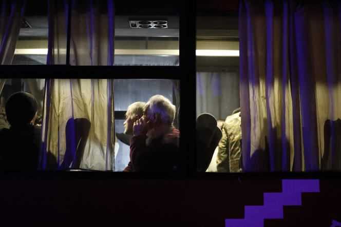 Newly released Armenian prisoners are seen through a bus window as they arrive at a military airport outside Yerevan, Armenia, Monday, December 14, 2020.