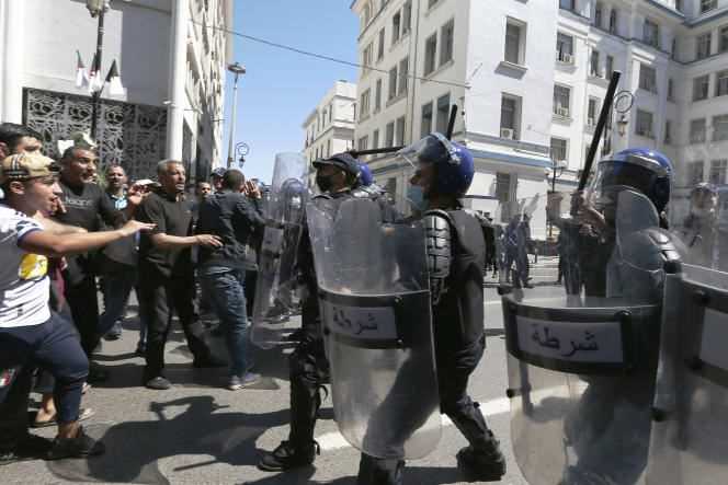 Protesters face police in Algiers, Friday, May 7, 2021, during a Hirak march.