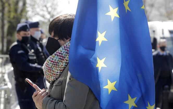 A Polish protester holds an EU flag outside the Constitutional Court in Warsaw on Wednesday April 28, 2021.