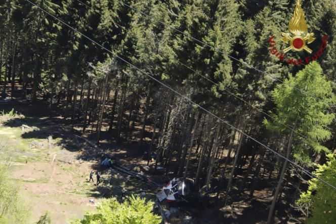 The wreckage of a cable car is seen on the ground after it collapsed near the top of the Stresa-Mottarone line in the Piedmont region of northern Italy on Sunday 23 May 2022.